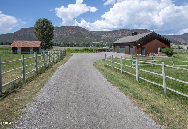 view of street with a mountain view and a rural view