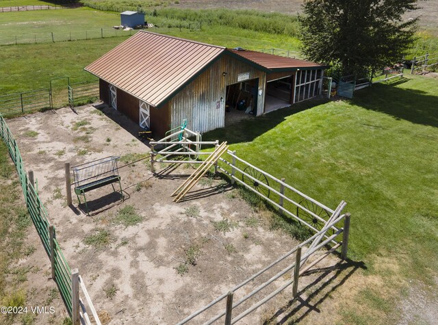 view of horse barn featuring a rural view