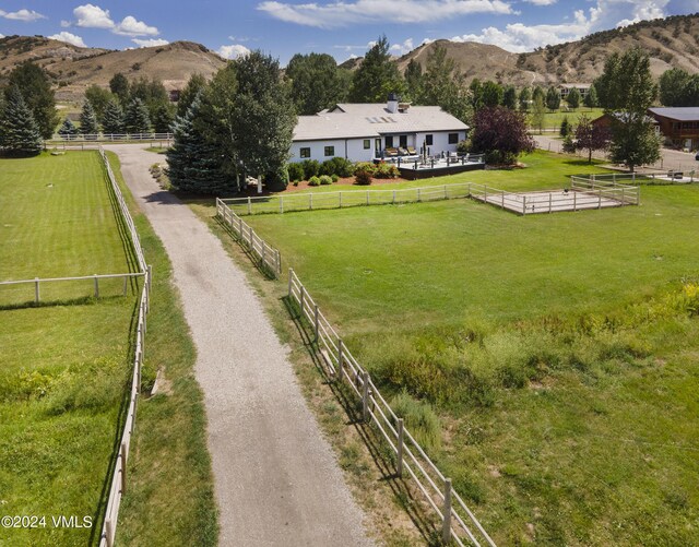 drone / aerial view featuring a mountain view and a rural view