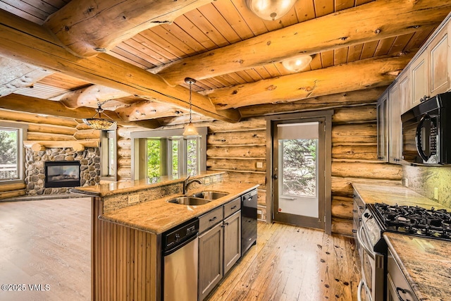 121 Hackamore Rd Unit A, Edwards, CO 81632 - kitchen with black appliances, healthy amount of natural light, light wood-style flooring, a wooden ceiling with exposed beams, and a stone fireplace