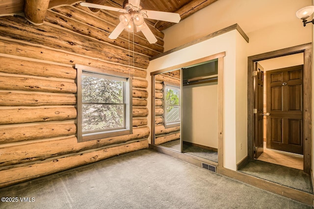 121 Hackamore Rd Unit A, Edwards, CO 81632 - unfurnished bedroom with carpet flooring, log walls, wood ceiling, a closet, and ceiling fan