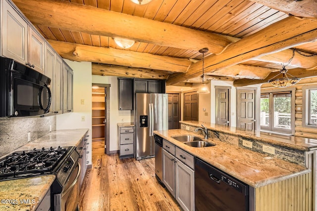 121 Hackamore Rd Unit A, Edwards, CO 81632 - kitchen with black appliances, a wood ceiling with exposed beams, light wood-type flooring, light stone countertops, and a center island with sink