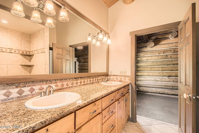 121 Hackamore Rd Unit A, Edwards, CO 81632 - full bath with log walls, double vanity, tile patterned floors, a closet, and backsplash