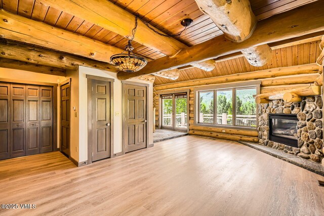 121 Hackamore Rd Unit A, Edwards, CO 81632 - unfurnished living room with a wooden ceiling with exposed beams, light wood-style floors, rustic walls, and a fireplace