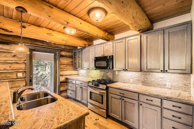 121 Hackamore Rd Unit A, Edwards, CO 81632 - kitchen with black microwave, stainless steel gas range, rustic walls, a wood ceiling with exposed beams, and light wood-style flooring