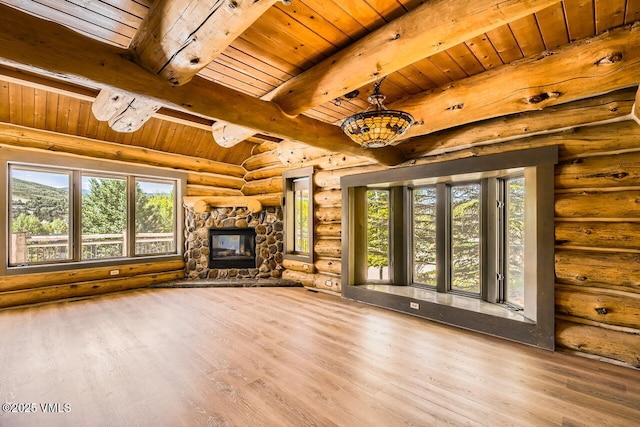 121 Hackamore Rd Unit A, Edwards, CO 81632 - unfurnished living room featuring rustic walls, a wood ceiling with exposed beams, wood finished floors, and a fireplace