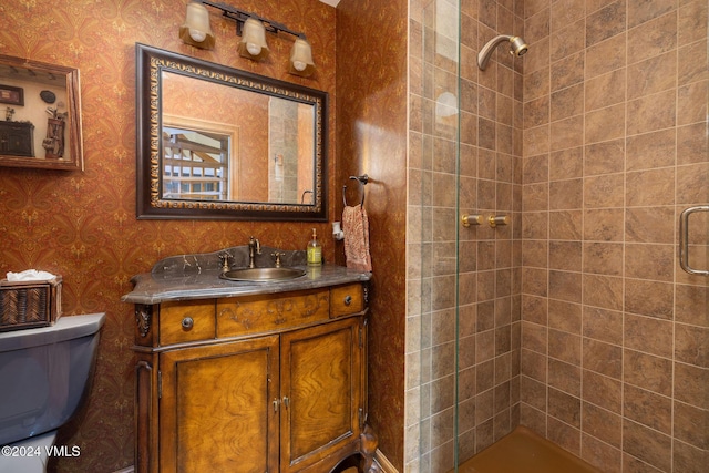 full bathroom with a shower stall, wallpapered walls, toilet, and vanity