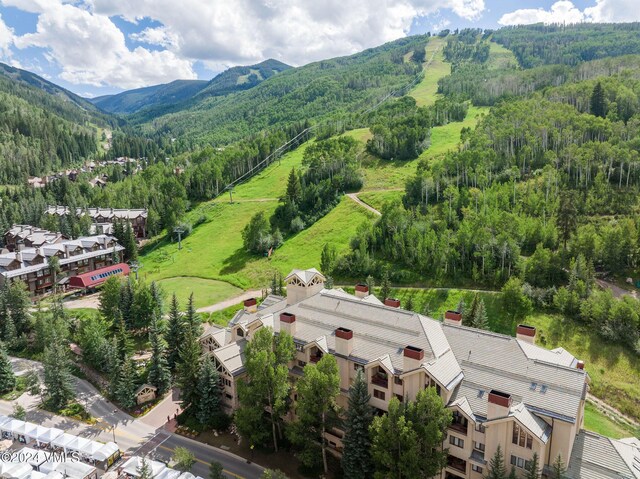 birds eye view of property with a forest view and a mountain view