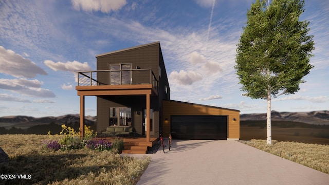 contemporary house with a garage and a balcony