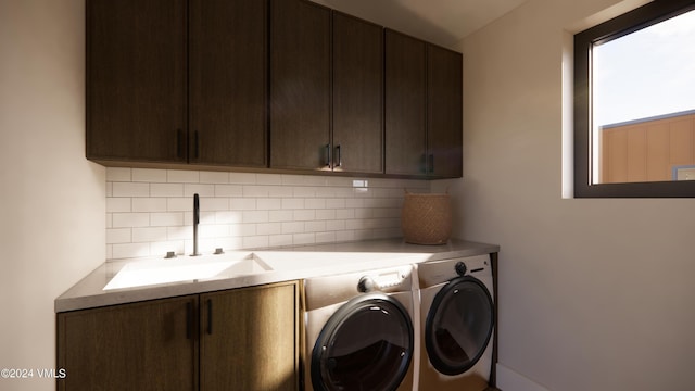 laundry area featuring cabinets, sink, and washing machine and dryer