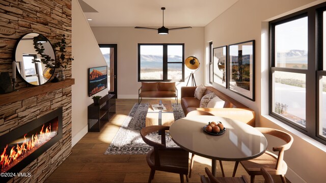 living room with wood-type flooring and a stone fireplace