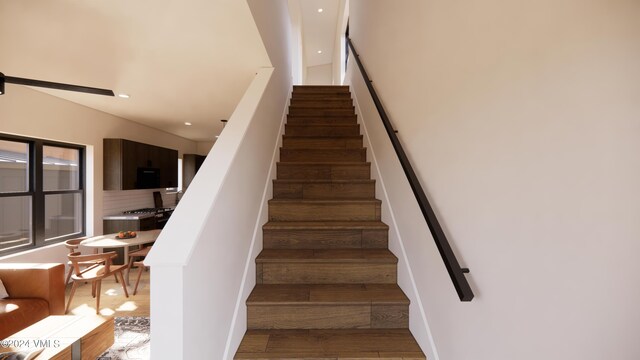 stairs featuring wood-type flooring