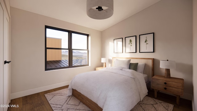 bedroom featuring wood-type flooring and vaulted ceiling