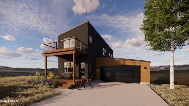 contemporary house featuring a garage and a balcony