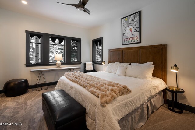 carpeted bedroom with ceiling fan and baseboards