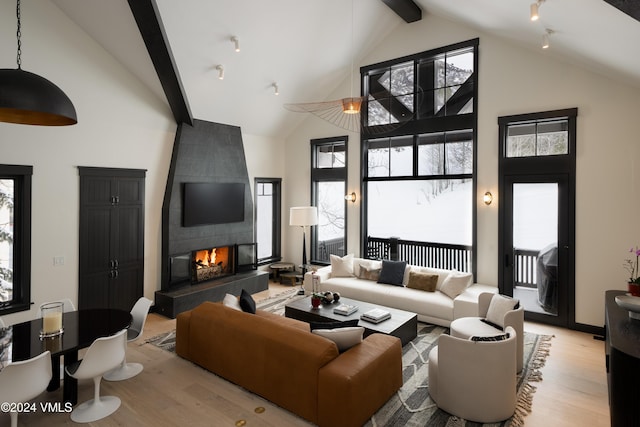 352 Cresta Rd, Edwards, CO 81632 - living room with high vaulted ceiling, light wood-type flooring, beamed ceiling, and a tiled fireplace