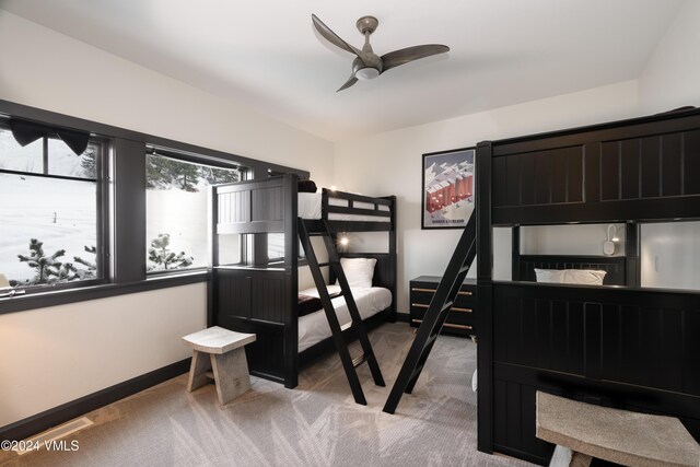 bedroom featuring light carpet, ceiling fan, and baseboards