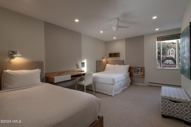 carpeted bedroom featuring a baseboard radiator and ceiling fan