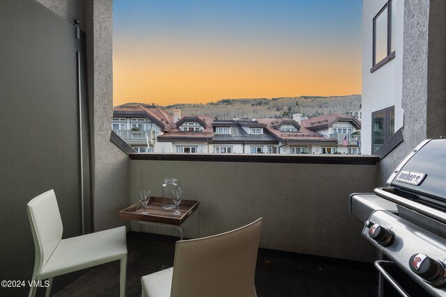 balcony at dusk with a grill