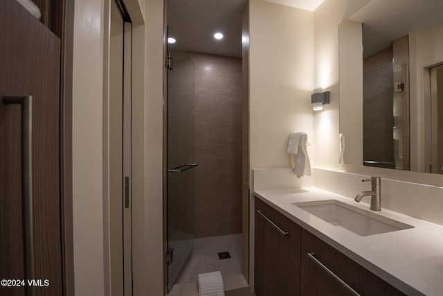 bathroom featuring vanity and an enclosed shower