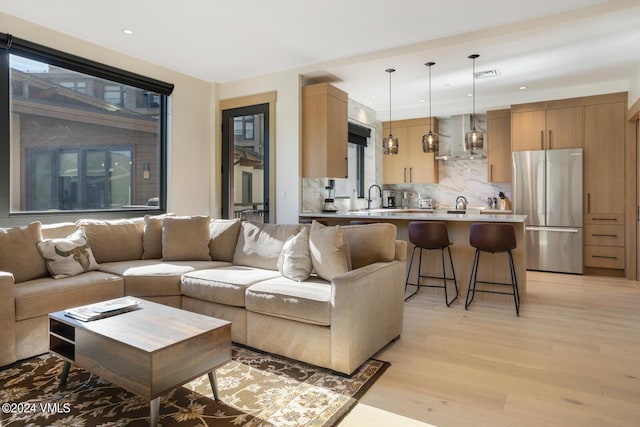 living room with sink and light hardwood / wood-style floors