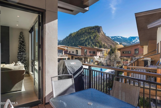 balcony with a mountain view and area for grilling