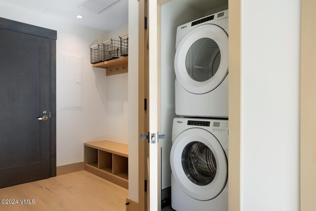 washroom featuring stacked washer / dryer