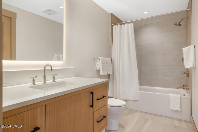 full bathroom featuring vanity, toilet, and shower / bath combo with shower curtain