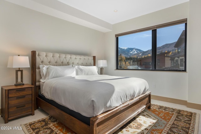 bedroom with a mountain view and carpet