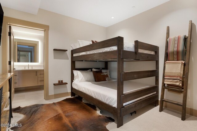 bedroom featuring sink and connected bathroom