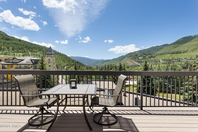 710 W Lionshead Cir Unit 501, Vail, CO 81657 - wooden terrace with a mountain view and a view of trees