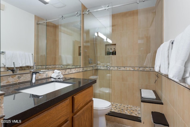 710 W Lionshead Cir Unit 501, Vail, CO 81657 - bathroom with vanity, a shower stall, tile walls, and decorative backsplash