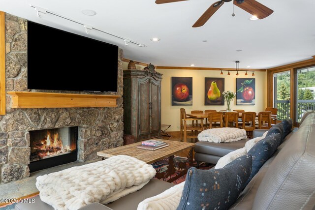 710 W Lionshead Cir Unit 501, Vail, CO 81657 - living area with a stone fireplace, ceiling fan, and crown molding