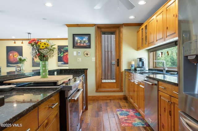 710 W Lionshead Cir Unit 501, Vail, CO 81657 - kitchen featuring stainless steel appliances, dark wood finished floors, recessed lighting, and dark stone counters