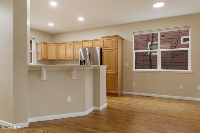 260 Longview Ave, Eagle, CO 81631 - kitchen with a breakfast bar area, recessed lighting, light wood-type flooring, stainless steel fridge with ice dispenser, and baseboards