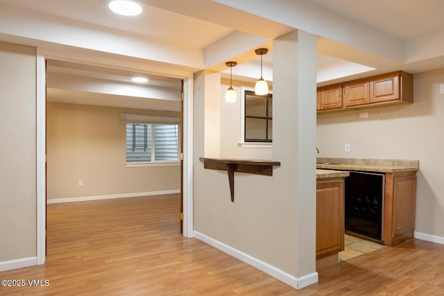 260 Longview Ave, Eagle, CO 81631 - interior space with light countertops, baseboards, decorative light fixtures, light wood-style floors, and beverage cooler