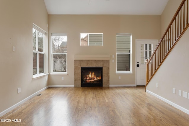 260 Longview Ave, Eagle, CO 81631 - unfurnished living room with stairway, baseboards, visible vents, a fireplace, and wood finished floors