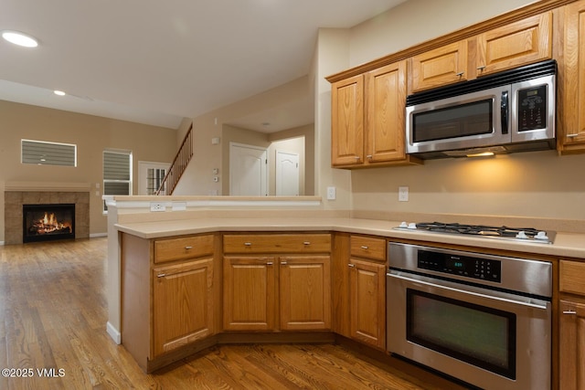 260 Longview Ave, Eagle, CO 81631 - kitchen featuring light countertops, a peninsula, open floor plan, stainless steel appliances, and light wood-style floors