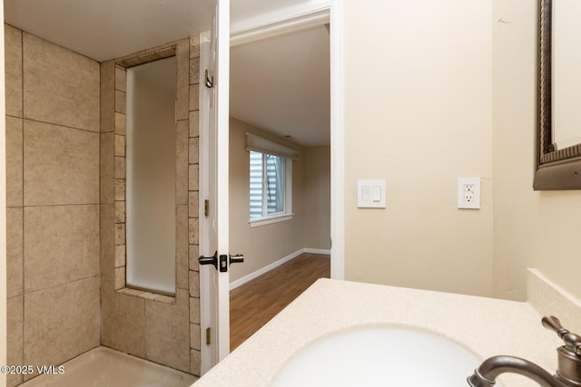 260 Longview Ave, Eagle, CO 81631 - bathroom featuring baseboards, a tile shower, wood finished floors, and a sink