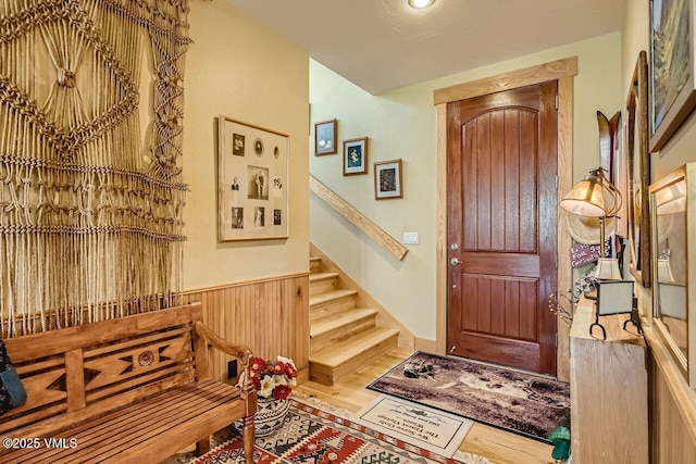 1987 Eagle Ranch Rd, Eagle, CO 81631 - entrance foyer with stairway, wood finished floors, and a wainscoted wall