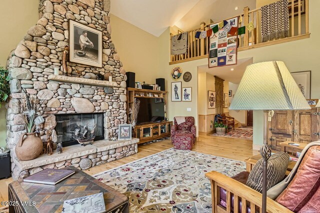 1987 Eagle Ranch Rd, Eagle, CO 81631 - living room featuring wood finished floors, vaulted ceiling, and a stone fireplace