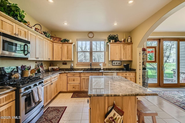 1987 Eagle Ranch Rd, Eagle, CO 81631 - kitchen with appliances with stainless steel finishes, a sink, recessed lighting, a breakfast bar area, and light tile patterned flooring