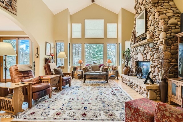 1987 Eagle Ranch Rd, Eagle, CO 81631 - living room with wood finished floors, healthy amount of natural light, arched walkways, high vaulted ceiling, and a fireplace