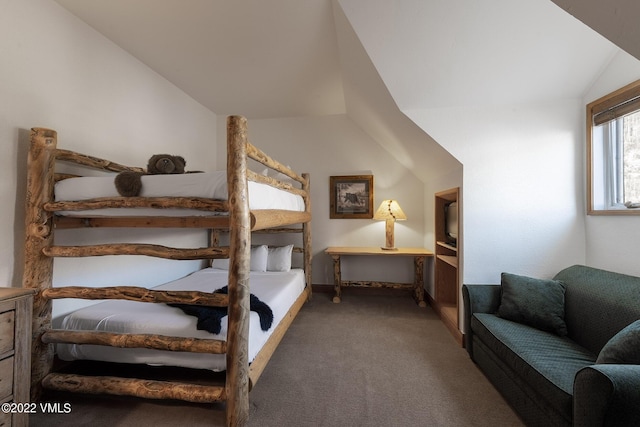 carpeted bedroom with lofted ceiling