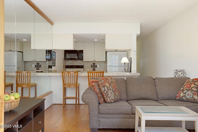 4506 Spruce Way Unit 2, Vail, CO 81657 - living room with light wood-style flooring and recessed lighting