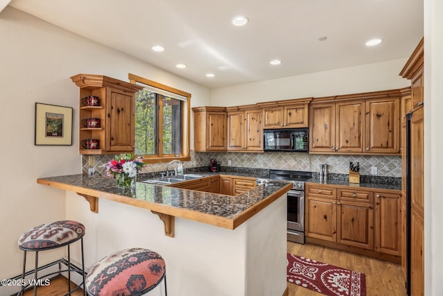 25 Cottage Cir, Edwards, CO 81632 - kitchen featuring stainless steel range oven, black microwave, tile counters, a peninsula, and a breakfast bar area