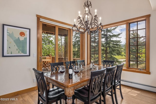 25 Cottage Cir, Edwards, CO 81632 - dining space with light wood finished floors, baseboard heating, a chandelier, and baseboards