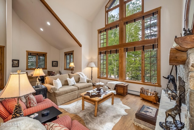 25 Cottage Cir, Edwards, CO 81632 - living area with high vaulted ceiling, wood finished floors, a stone fireplace, baseboard heating, and recessed lighting