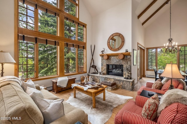 25 Cottage Cir, Edwards, CO 81632 - living area with high vaulted ceiling, a chandelier, a stone fireplace, baseboard heating, and wood finished floors