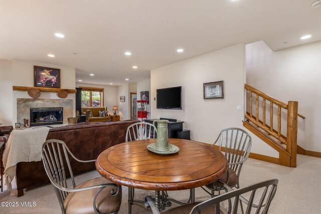 25 Cottage Cir, Edwards, CO 81632 - dining space with a tile fireplace, light colored carpet, recessed lighting, stairway, and baseboards